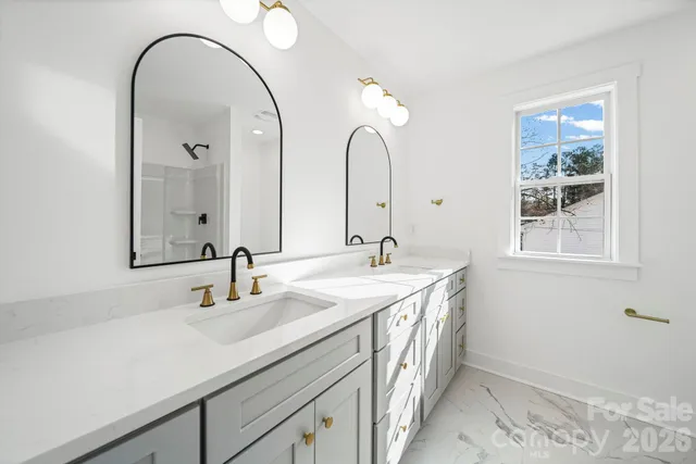 a bathroom with a double vanity sink and a mirror