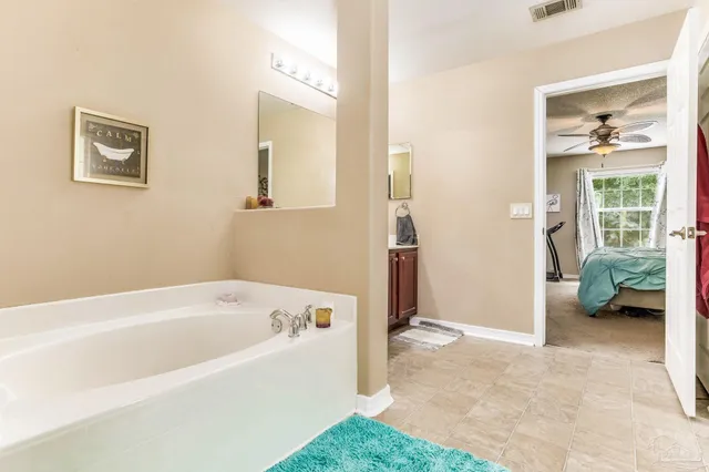 a kitchen with stainless steel appliances granite countertop a refrigerator a stove and a sink