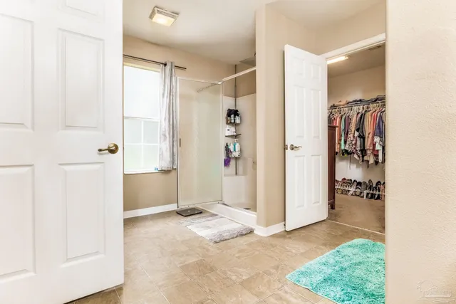 a view of a dining room with furniture and a chandelier