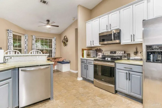 a backyard of a house with yard table and chairs