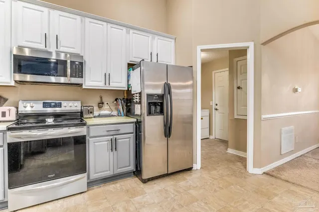 a balcony with furniture and large windows