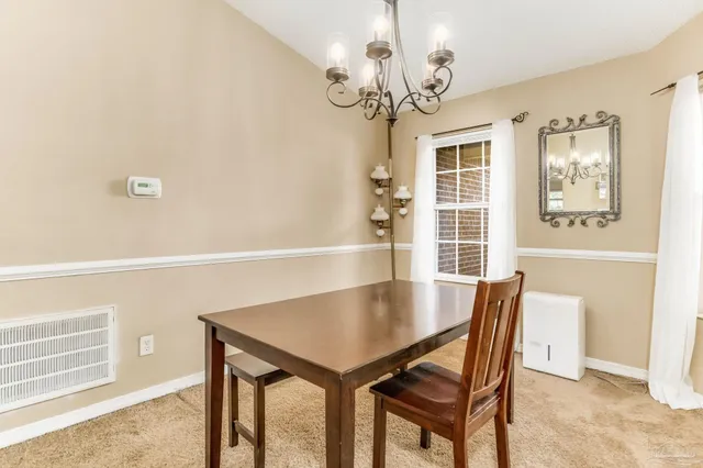 a view of backyard with table and chairs and wooden fence