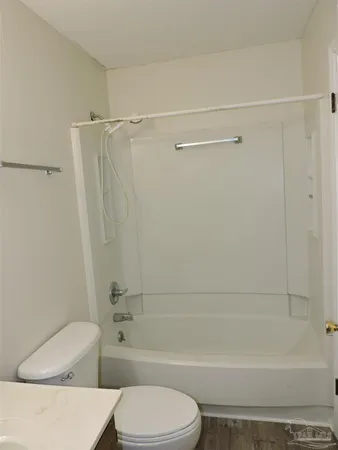 a bathroom with a toilet and a bathtub