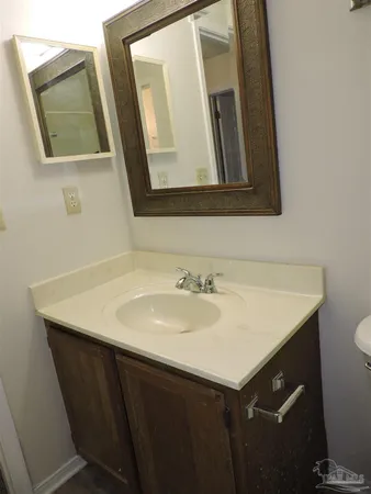 a bathroom with a sink vanity and a mirror