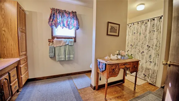 a bedroom with a bed and a flat tv screen on dresser