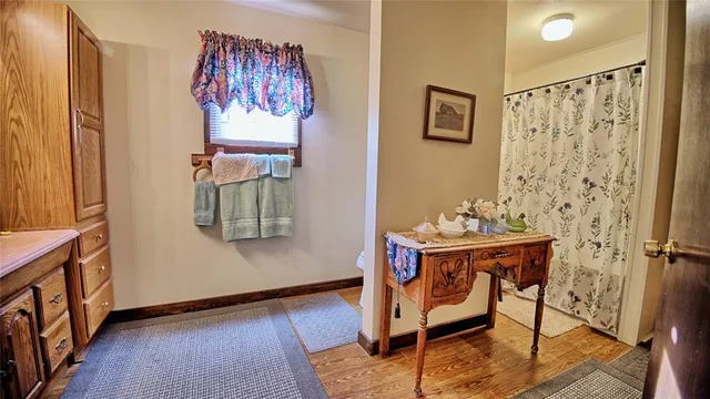 a bedroom with a bed and a flat tv screen on dresser