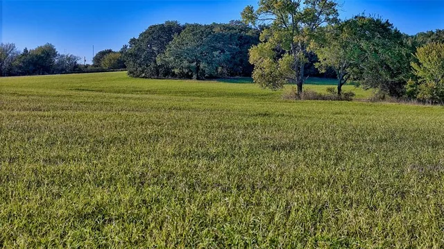 a view of wooden house with a yard