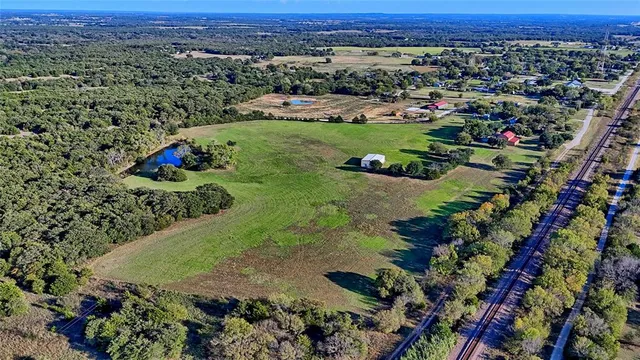 an aerial view of a house with a yard
