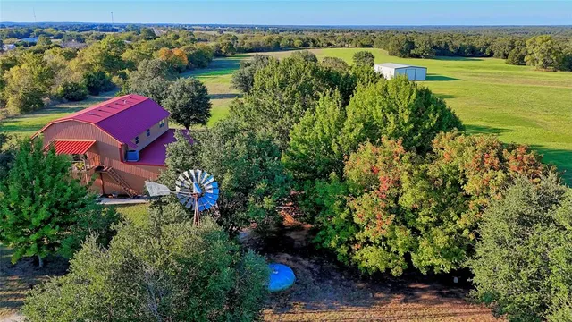 an aerial view of a house with a lake view
