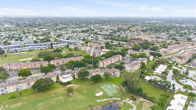 an aerial view of residential houses with outdoor space and swimming pool
