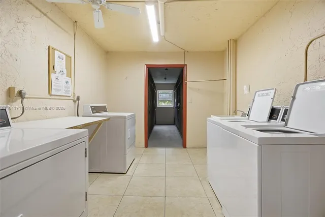 a room with a sink a washer and dryer