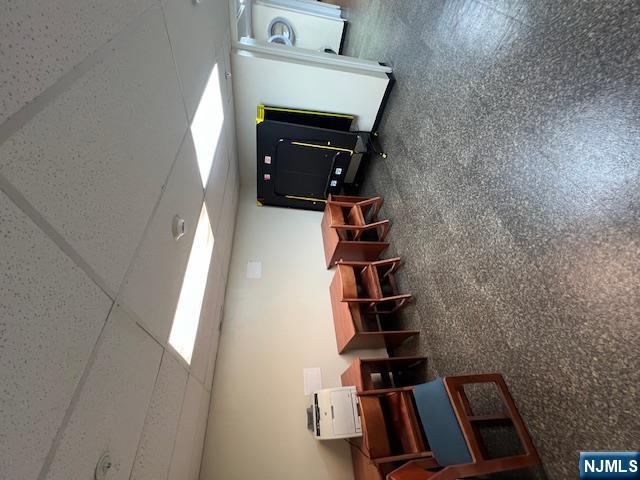 169 Barclay Street, Unit 105 Paterson, NJ 07503 - Photo 12 of 13 a living room with furniture and a mirror