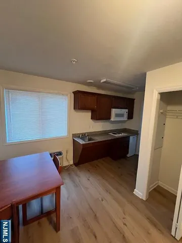 a room with furniture pool table and wooden floor
