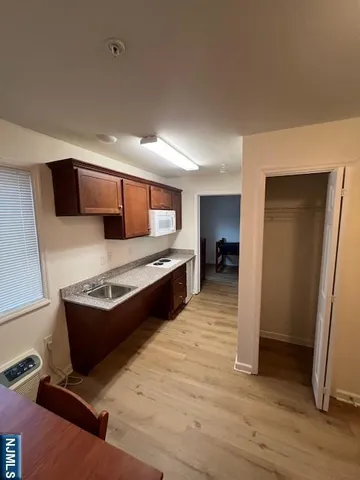 a large kitchen with stainless steel appliances granite countertop a stove and a refrigerator