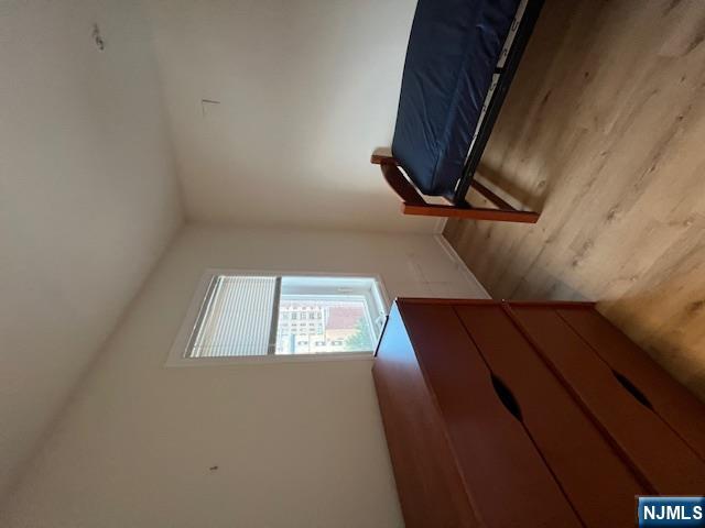 169 Barclay Street, Unit 105 Paterson, NJ 07503 - Photo 5 of 13 a bedroom with a bed and window