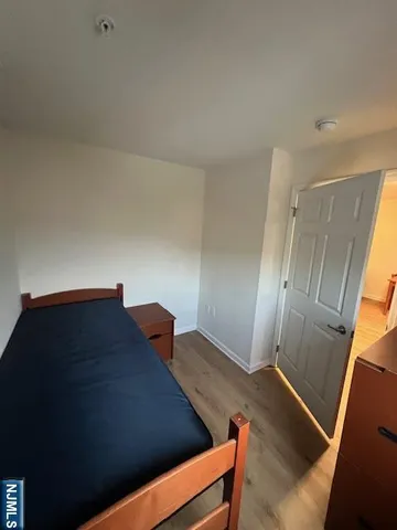 a view of an empty room and wooden floor