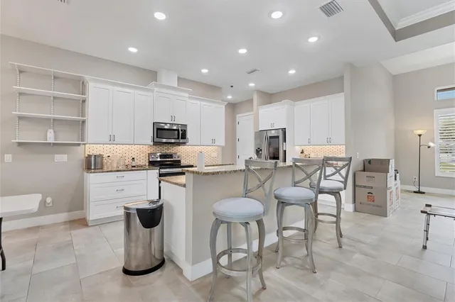 a bedroom with furniture a flat screen tv and a window