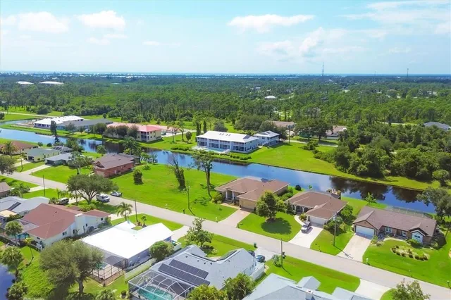 an aerial view of a house with garden space and a street view