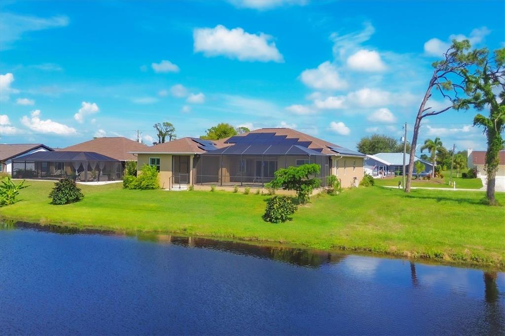 249 Rotonda Circle Rotonda West, FL 33947 - Photo 49 of 71 a view of a big house with a big yard