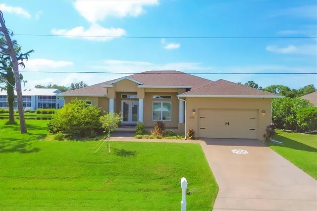 a front view of a house with a yard and garage