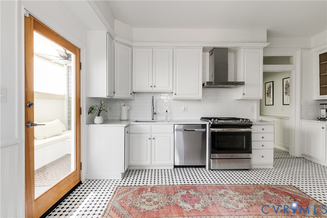 307 North 31st Street Richmond, VA 23223 - Photo 17 of 45 a kitchen with a stove and white cabinets