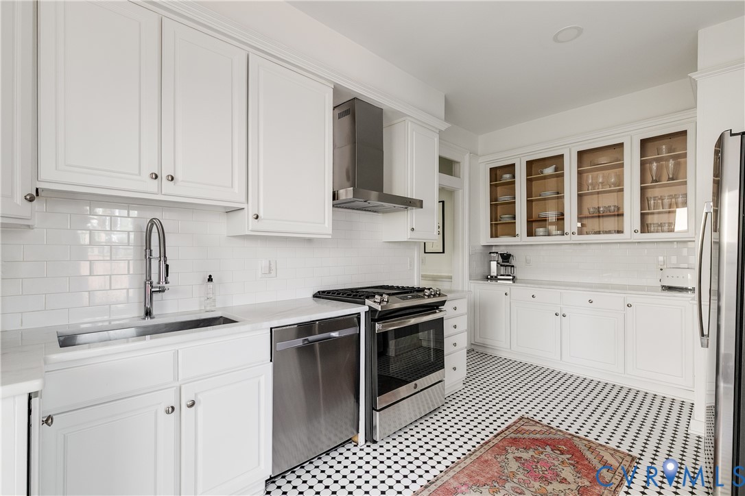 307 North 31st Street Richmond, VA 23223 - Photo 18 of 45 a kitchen with granite countertop a stove top oven sink and cabinets