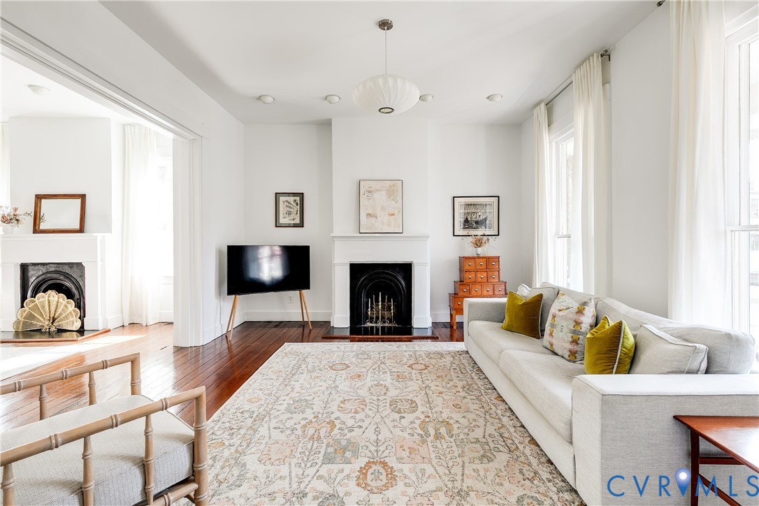307 North 31st Street Richmond, VA 23223 - Photo 2 of 45 a living room with furniture a flat screen tv and a fireplace