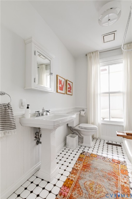 307 North 31st Street Richmond, VA 23223 - Photo 22 of 45 a bathroom with a sink toilet and window