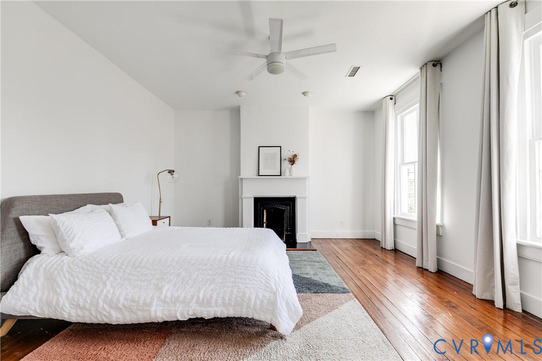 307 North 31st Street Richmond, VA 23223 - Photo 27 of 45 a bed room with a bed and a fireplace