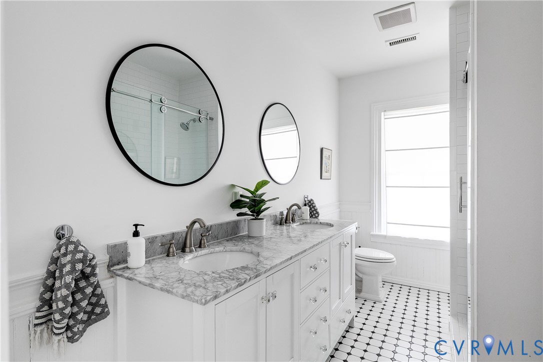 307 North 31st Street Richmond, VA 23223 - Photo 33 of 45 a bathroom with a double vanity sink and a mirror