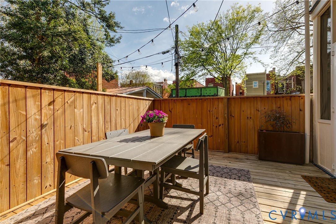 307 North 31st Street Richmond, VA 23223 - Photo 42 of 45 a view of a patio with table and chairs with wooden floor and fence