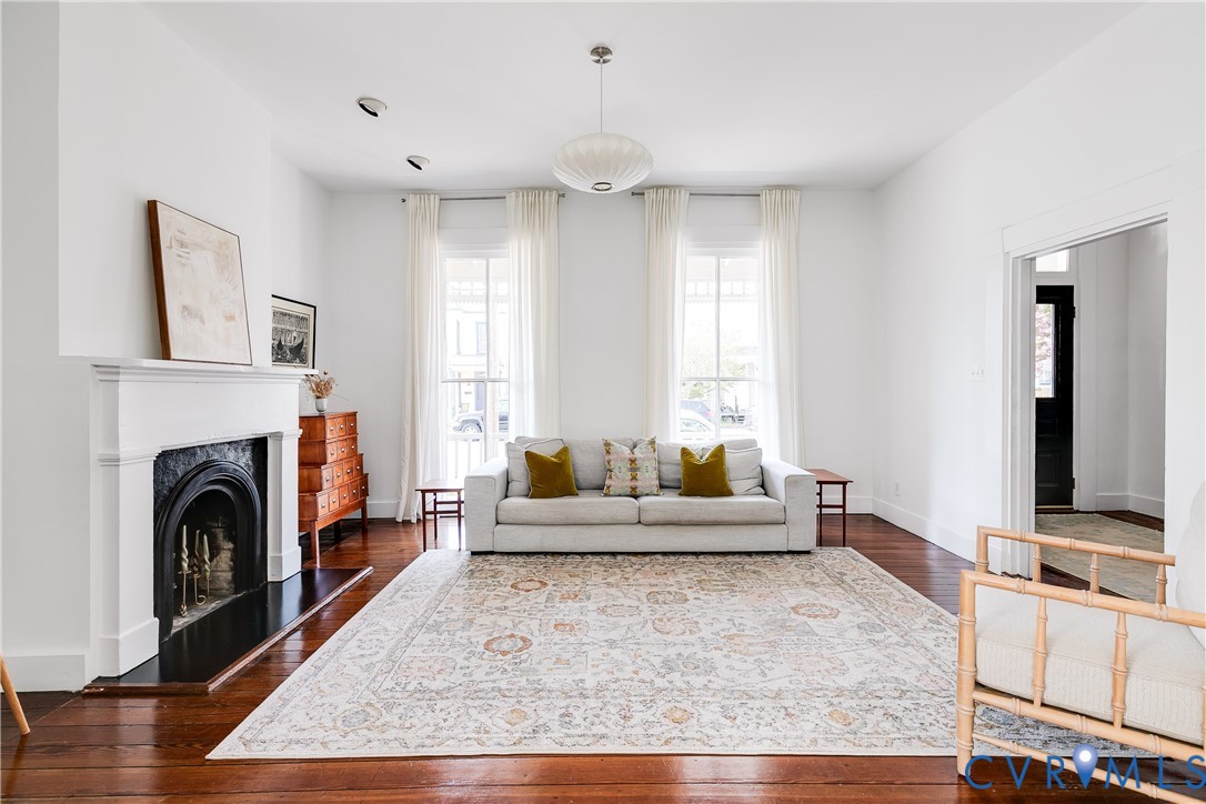 307 North 31st Street Richmond, VA 23223 - Photo 9 of 45 a living room with furniture a large window and a fireplace