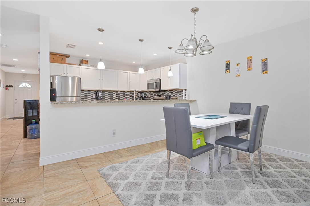 721-723 Homer Avenue South, Unit 723 Lehigh Acres, FL 33973 - Photo 12 of 36 a view of a dining room with furniture