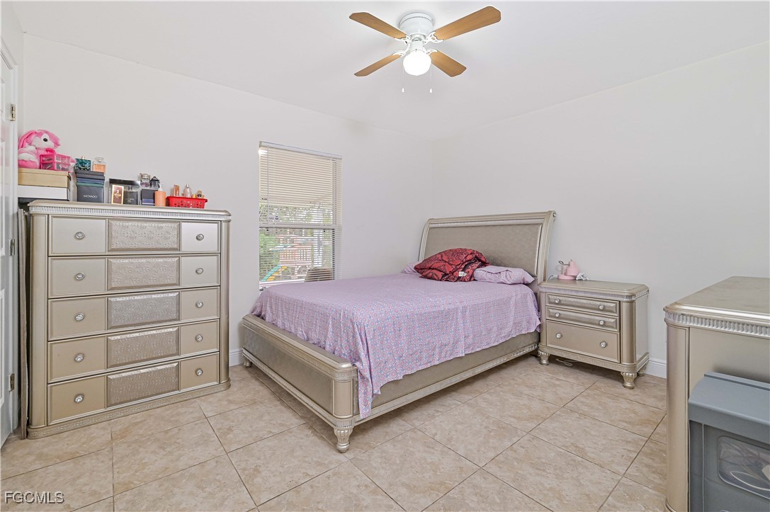 721-723 Homer Avenue South, Unit 723 Lehigh Acres, FL 33973 - Photo 13 of 36 a bedroom with a bed and cabinets