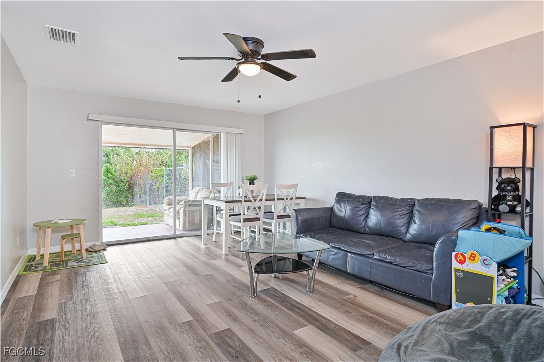 721-723 Homer Avenue South, Unit 723 Lehigh Acres, FL 33973 - Photo 22 of 36 a living room with furniture and a large window
