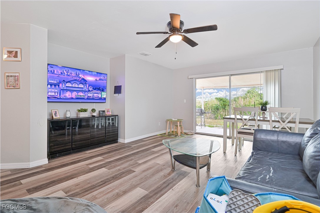 721-723 Homer Avenue South, Unit 723 Lehigh Acres, FL 33973 - Photo 25 of 36 a living room with furniture and a floor to ceiling window