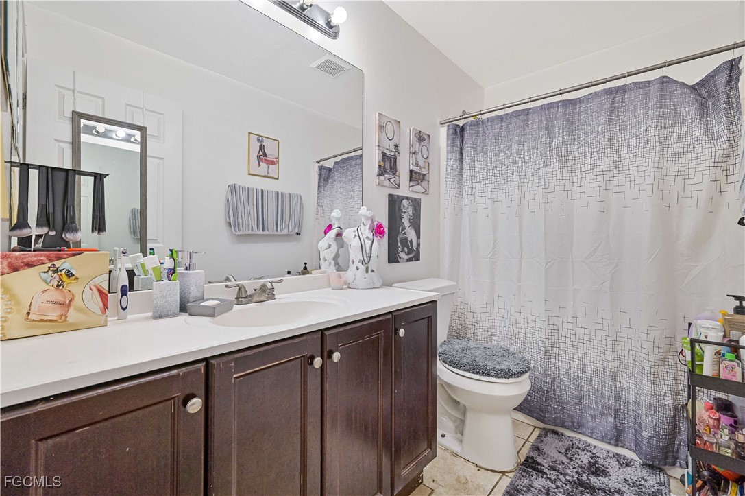721-723 Homer Avenue South, Unit 723 Lehigh Acres, FL 33973 - Photo 31 of 36 a bathroom with a sink vanity mirror and toilet