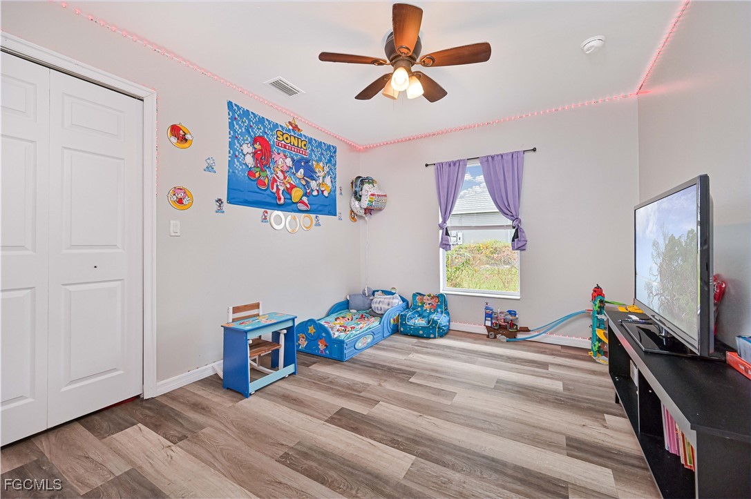 721-723 Homer Avenue South, Unit 723 Lehigh Acres, FL 33973 - Photo 32 of 36 a bedroom with a bed and a flat screen tv