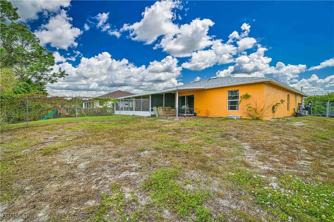721-723 Homer Avenue South, Unit 723 Lehigh Acres, FL 33973 - Photo 5 of 36 a view of a house with a big yard