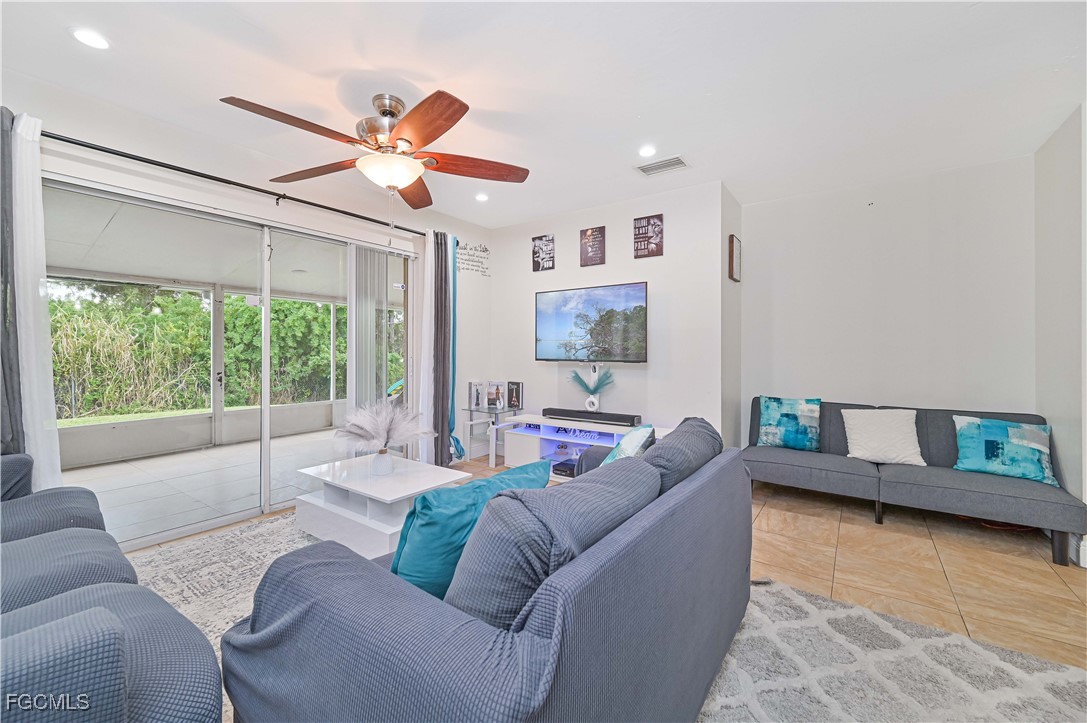 721-723 Homer Avenue South, Unit 723 Lehigh Acres, FL 33973 - Photo 8 of 36 a living room with furniture and a large window