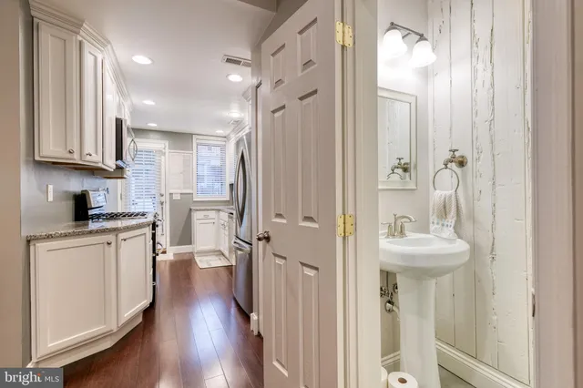 a bathroom with a sink a mirror and a shower