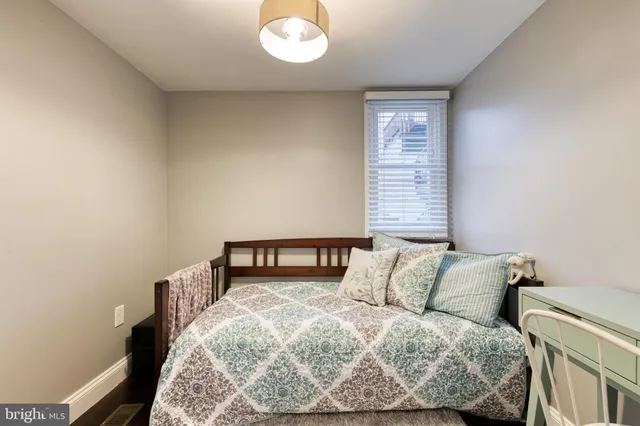 a bedroom with a bed and window