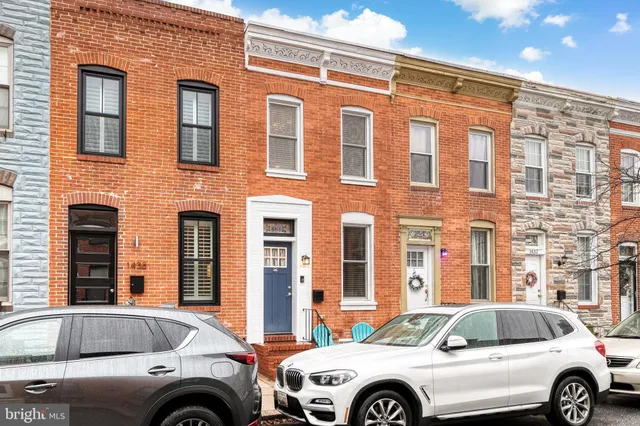 a front view of a house with parking space