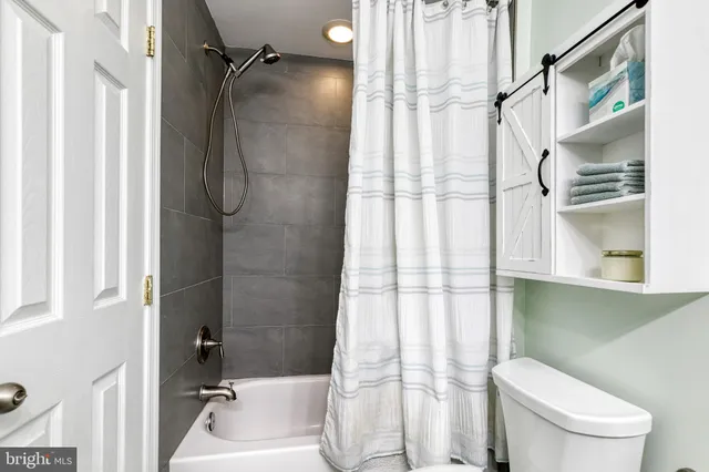 a bathroom with a toilet and shower