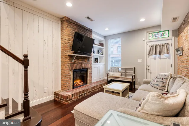 a living room with furniture fireplace and flat screen tv