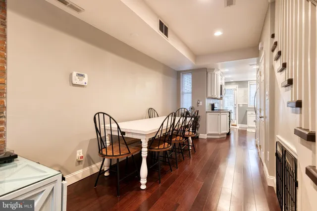 a view of a dining room with furniture and wooden floor