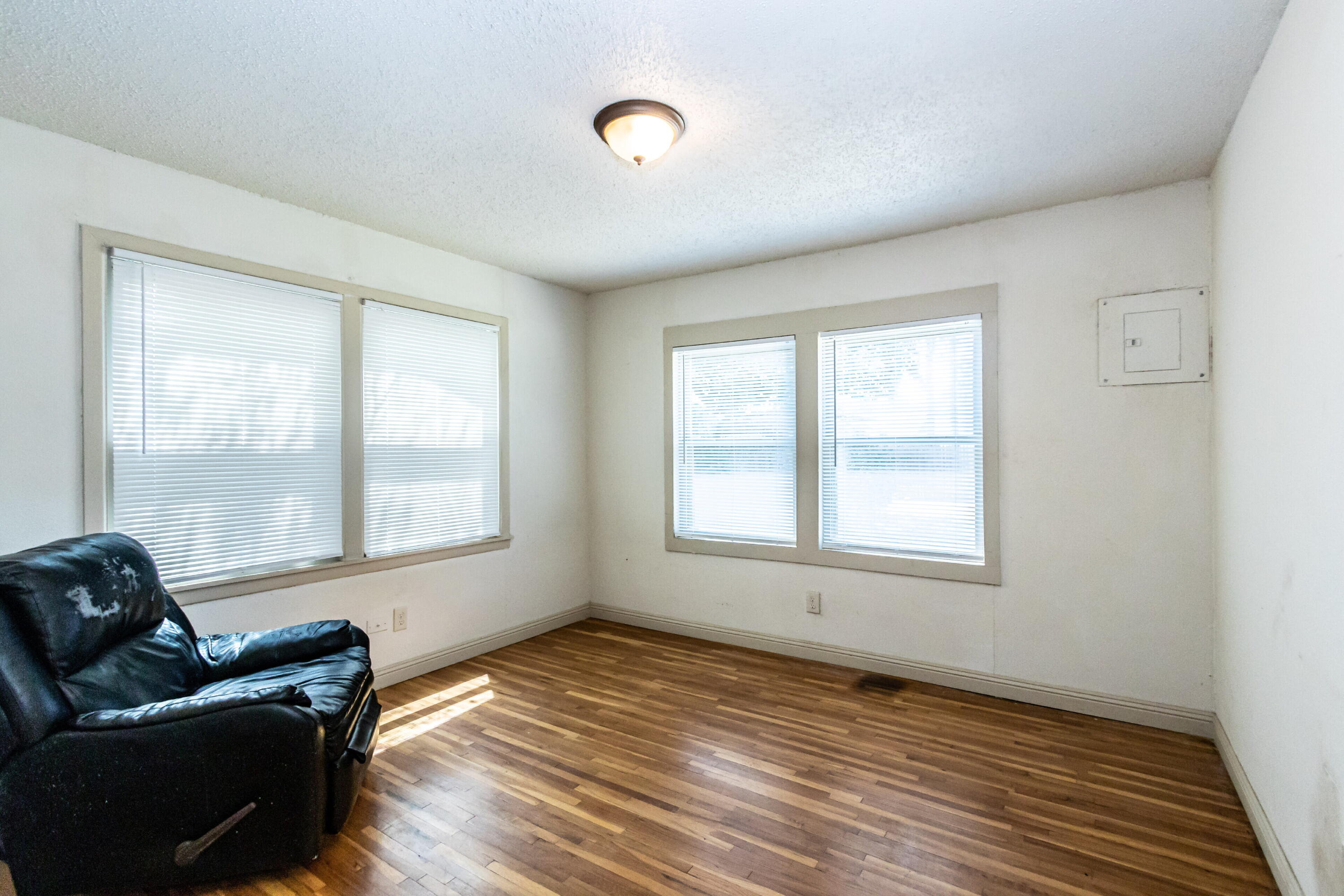 2611 44th Street Lubbock, TX 79413 - Photo 11 of 18 a view of an empty room with wooden floor and a window