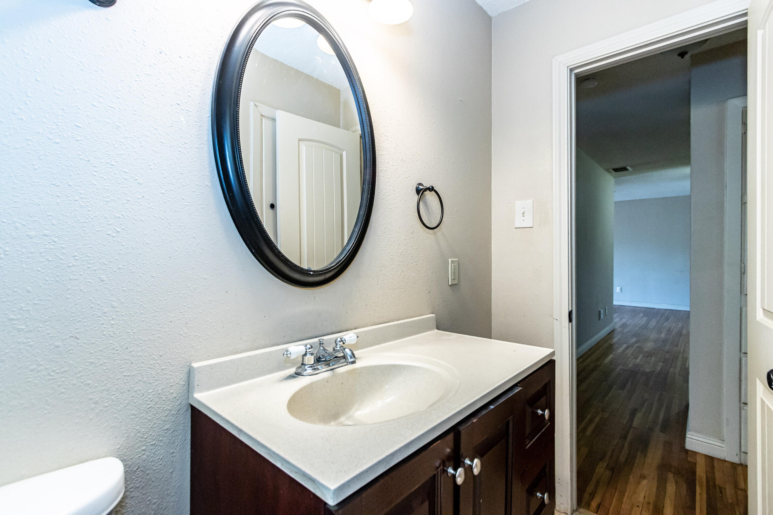 2611 44th Street Lubbock, TX 79413 - Photo 16 of 18 a bathroom with a sink and a mirror