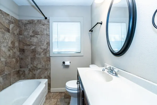 a bathroom with a sink toilet and a bathtub