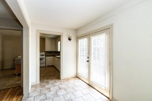 a view of a hallway with a livingroom and a bathroom